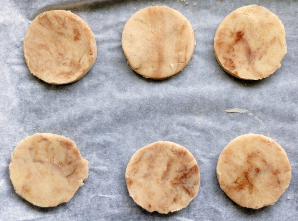 Raw sugar cookie dough on parchment.