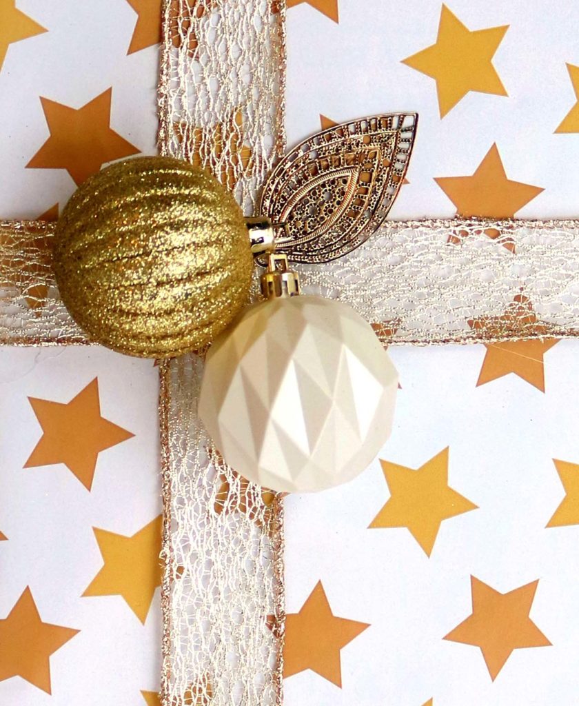 Upcycle old Christmas or Yule ornaments to create gorgeous accents on presents.