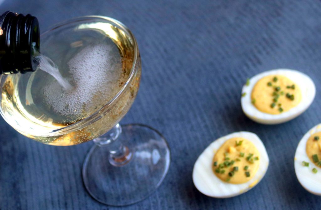 Champagne and eggs are a most elegant pairing for spring brunches, Easter or Ostara festivities. This deviled eggs recipe adds the acidity and brightness of sparkling white wine to the rich, creamy decadence of eggs.