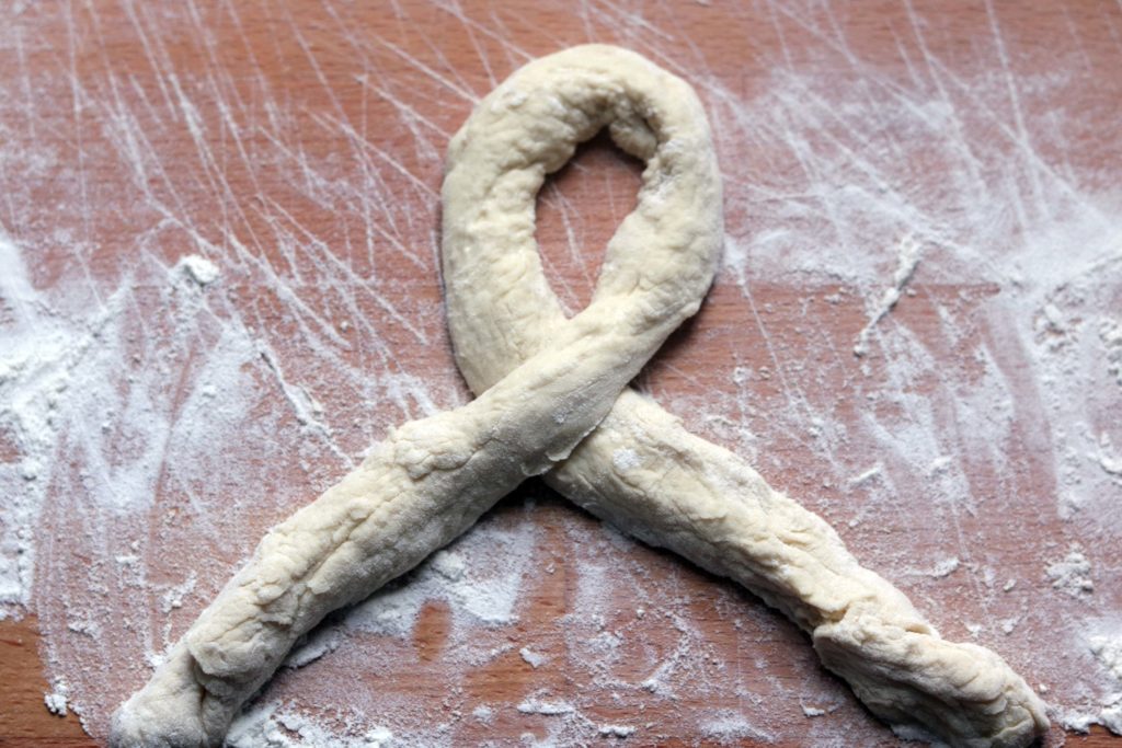 Tying a triquetra from bread dough.