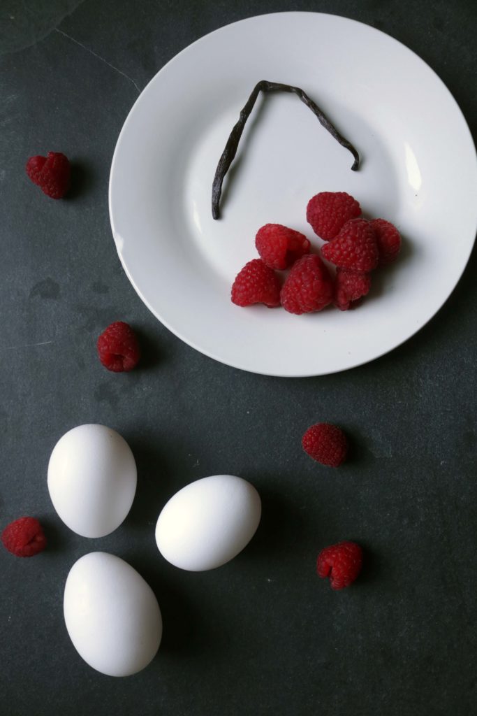 Eggs, raspberries and a vanilla bean. Fresh ingredients for a fresh batch of creme brulee.