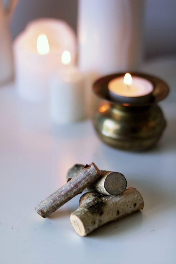 A tiny pile of wood symbolizes the winter hearth fire.