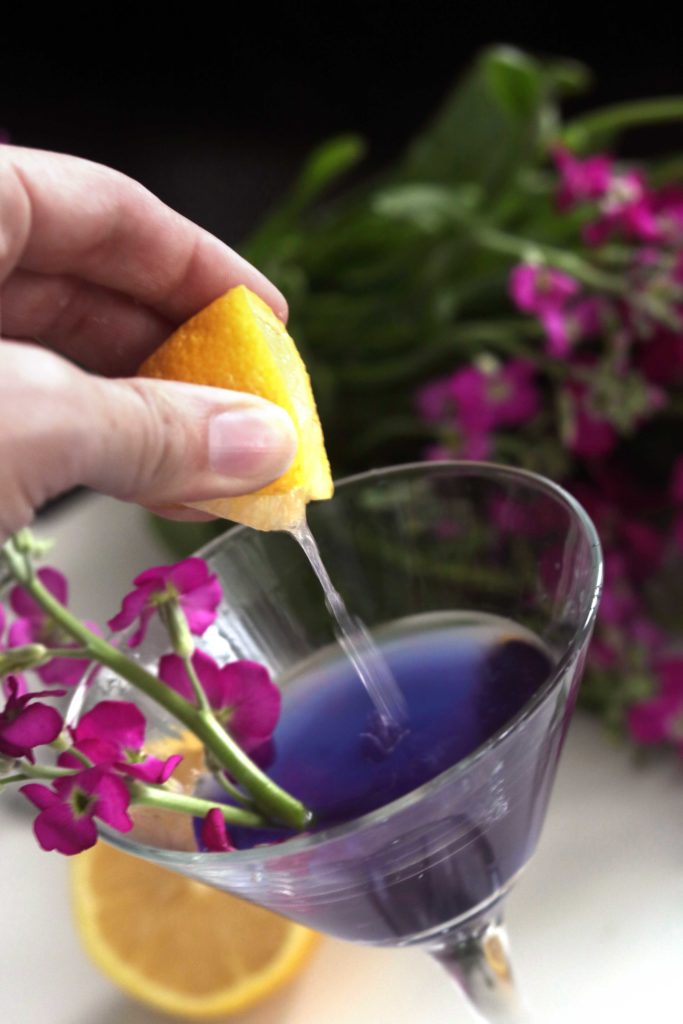 A splash of tart lemon balances this purple fairy floral cocktail.