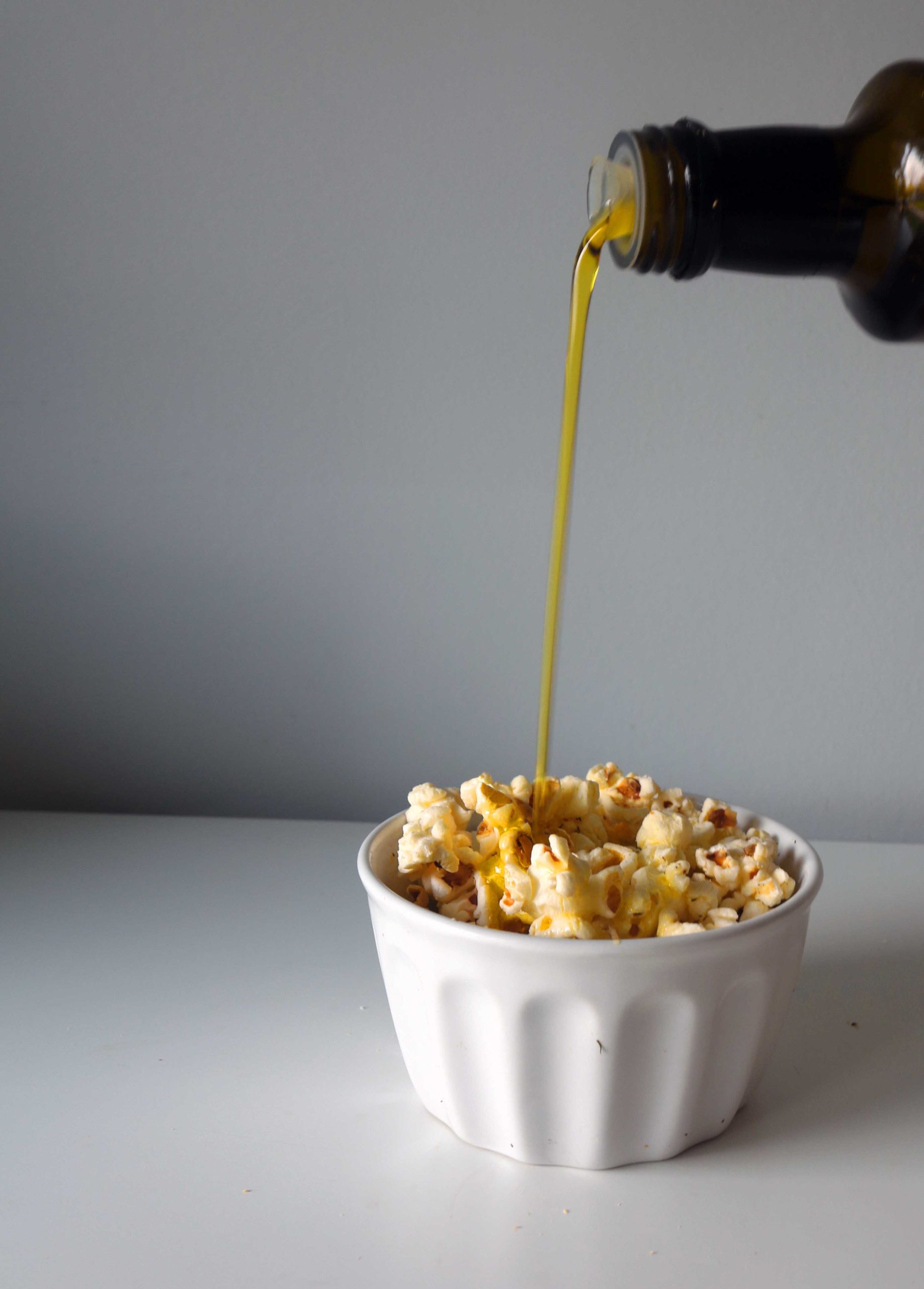 Olive oil poured on popcorn.