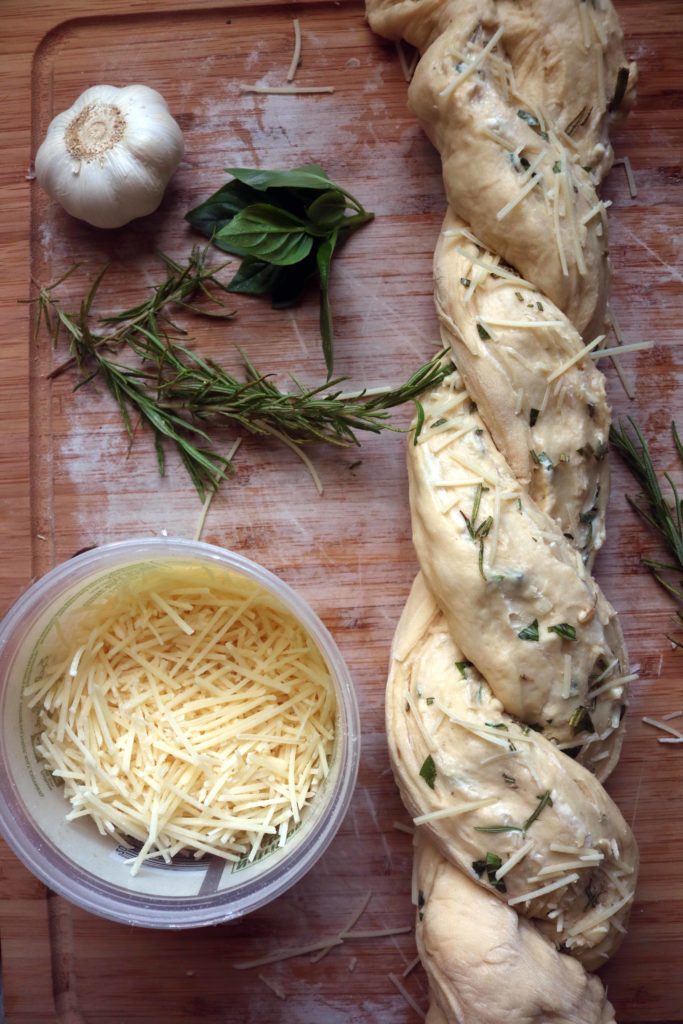 Twisting up bread dough before it goes in the oven to get crusty and beautiful.