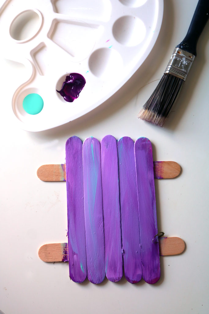 Painting a fairy door in layers.