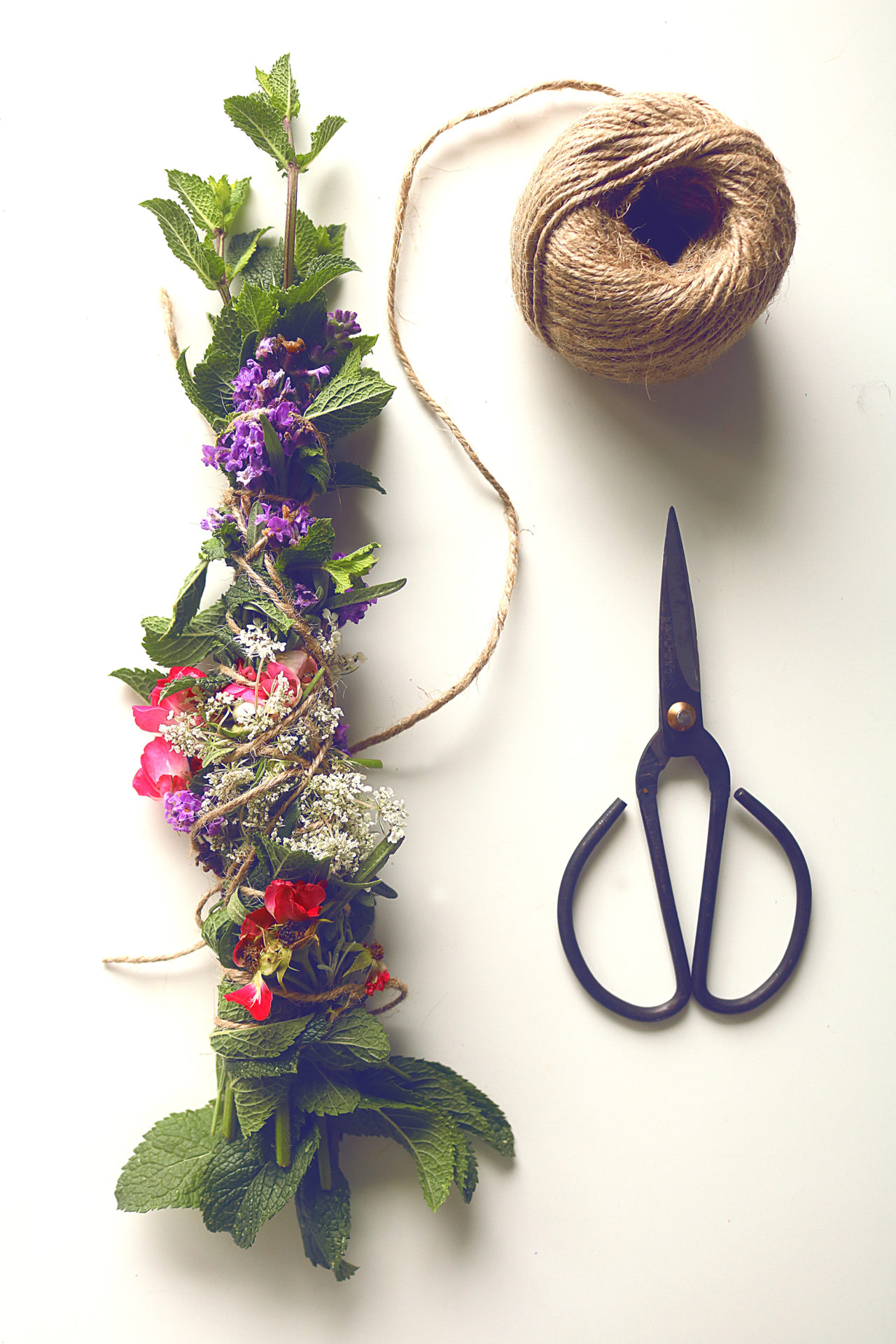 Have you seen all those beautiful incense wands on Etsy? They're super easy to make from garden herbs and flowers. Here's how.